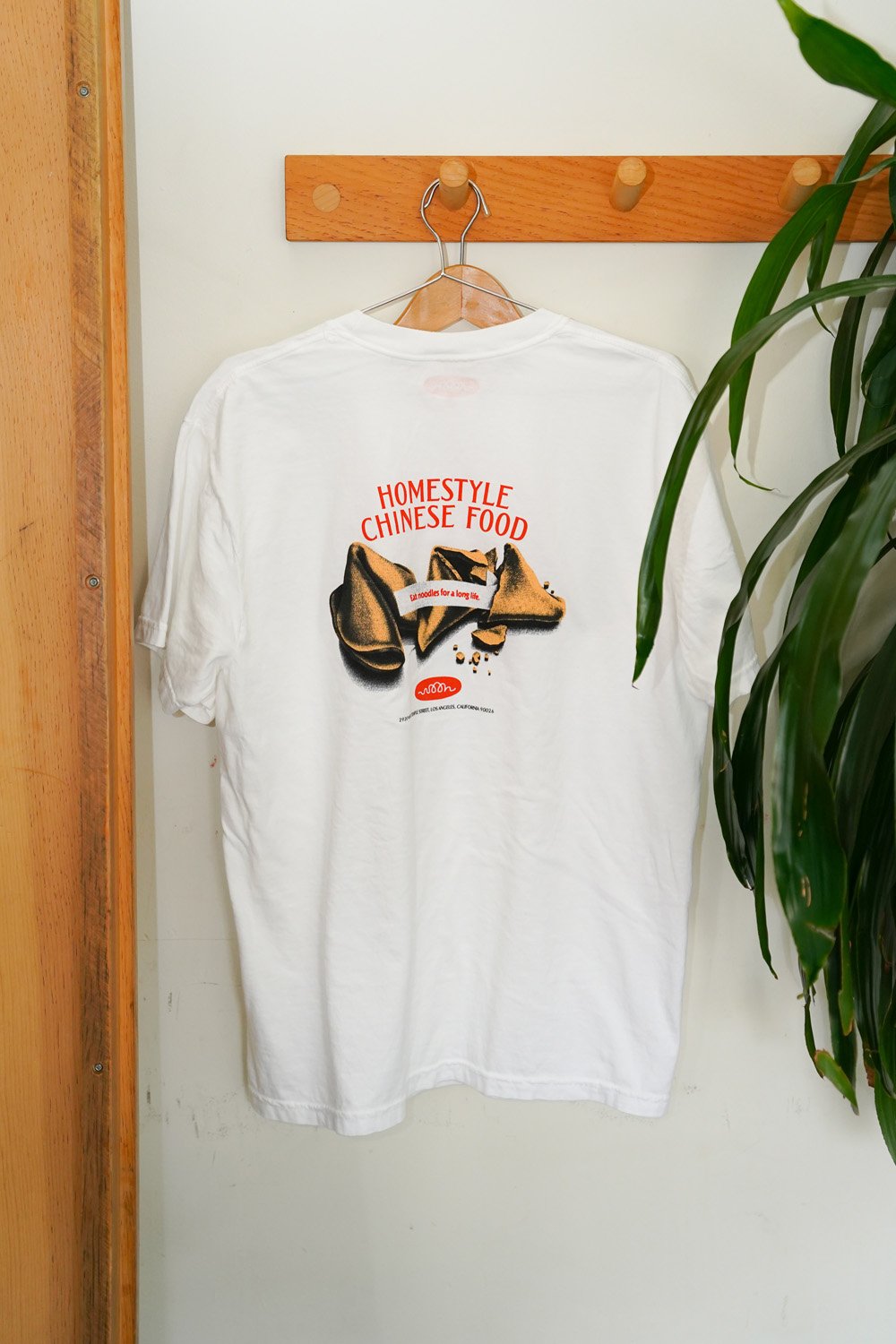 White tshirt hanging on a hookl.