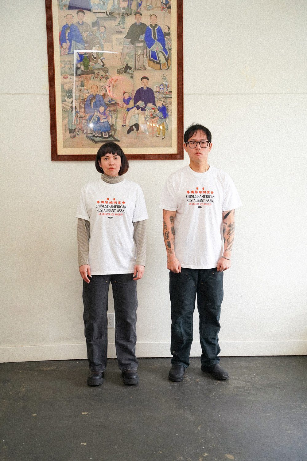 two people wearing white tshirts