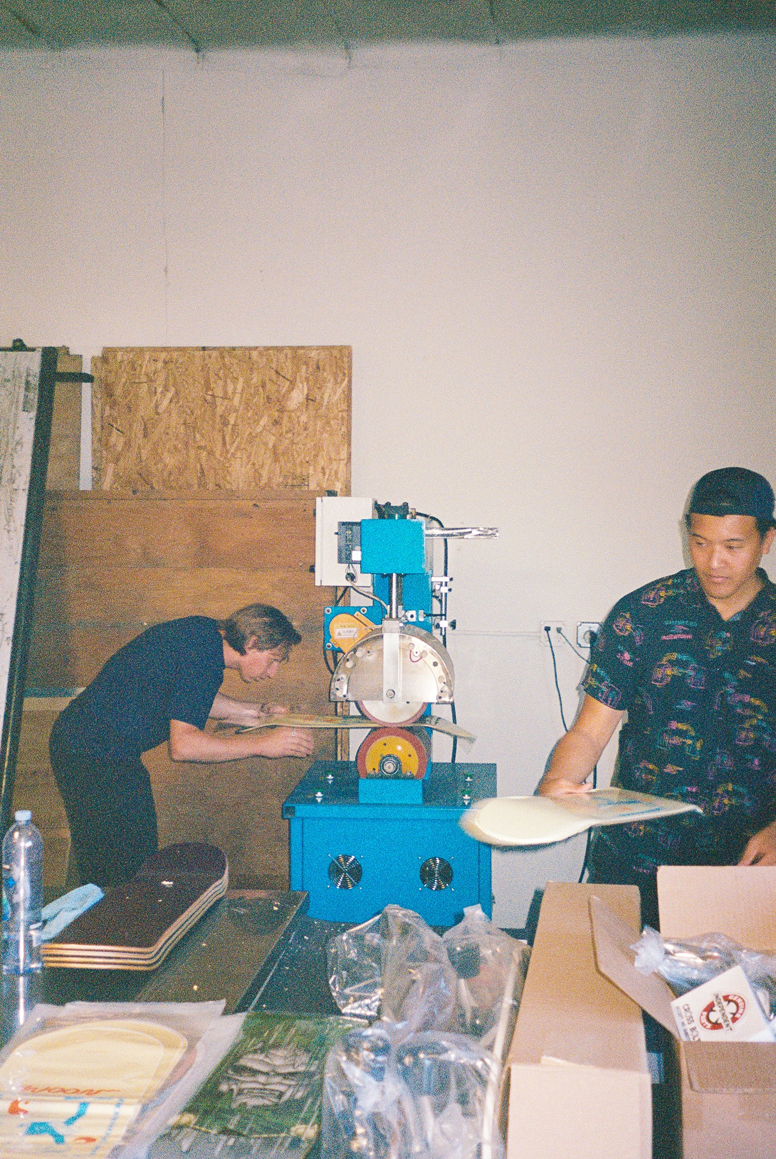 Two people making skatebaords