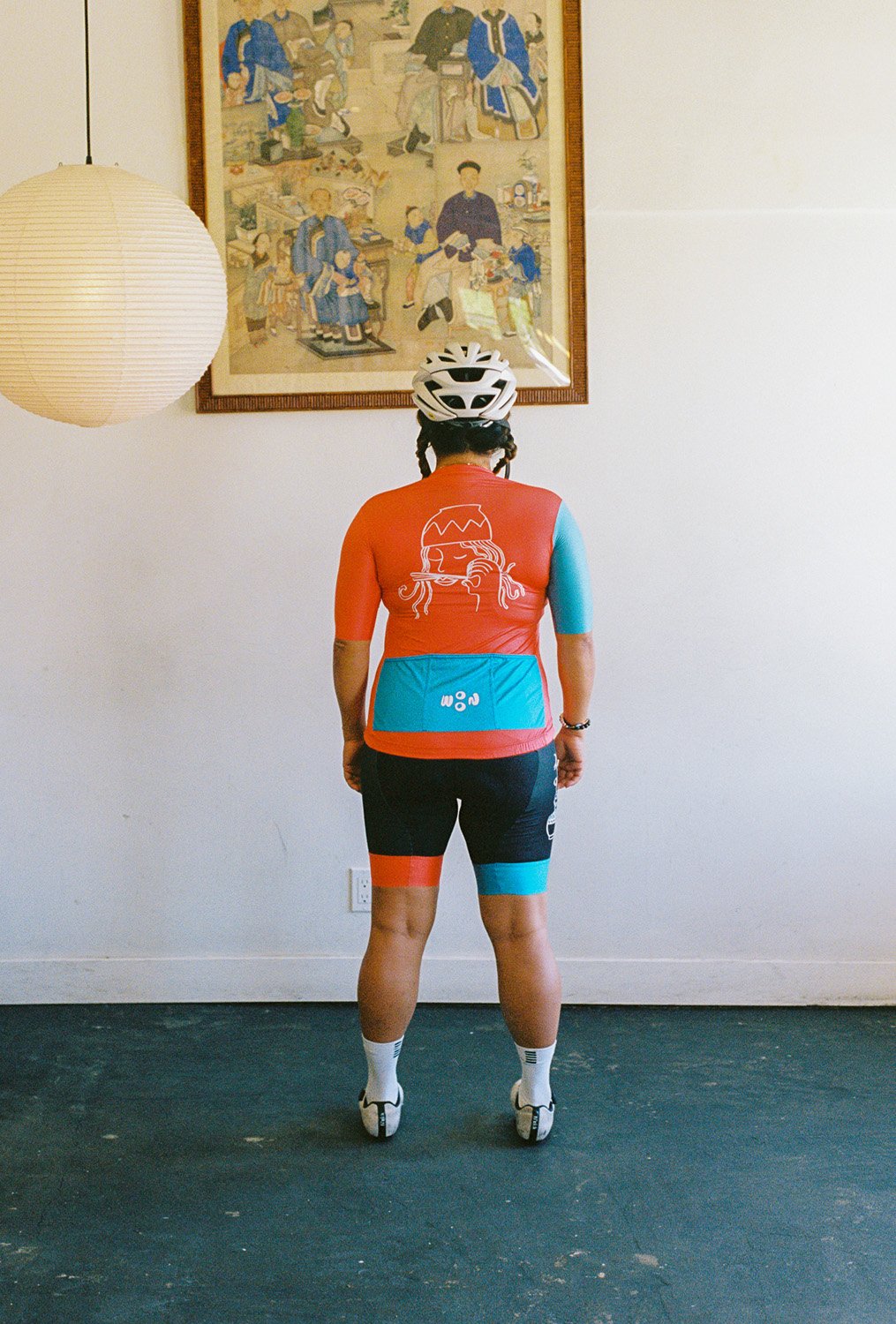 A woman wearing a woon cycling jersey