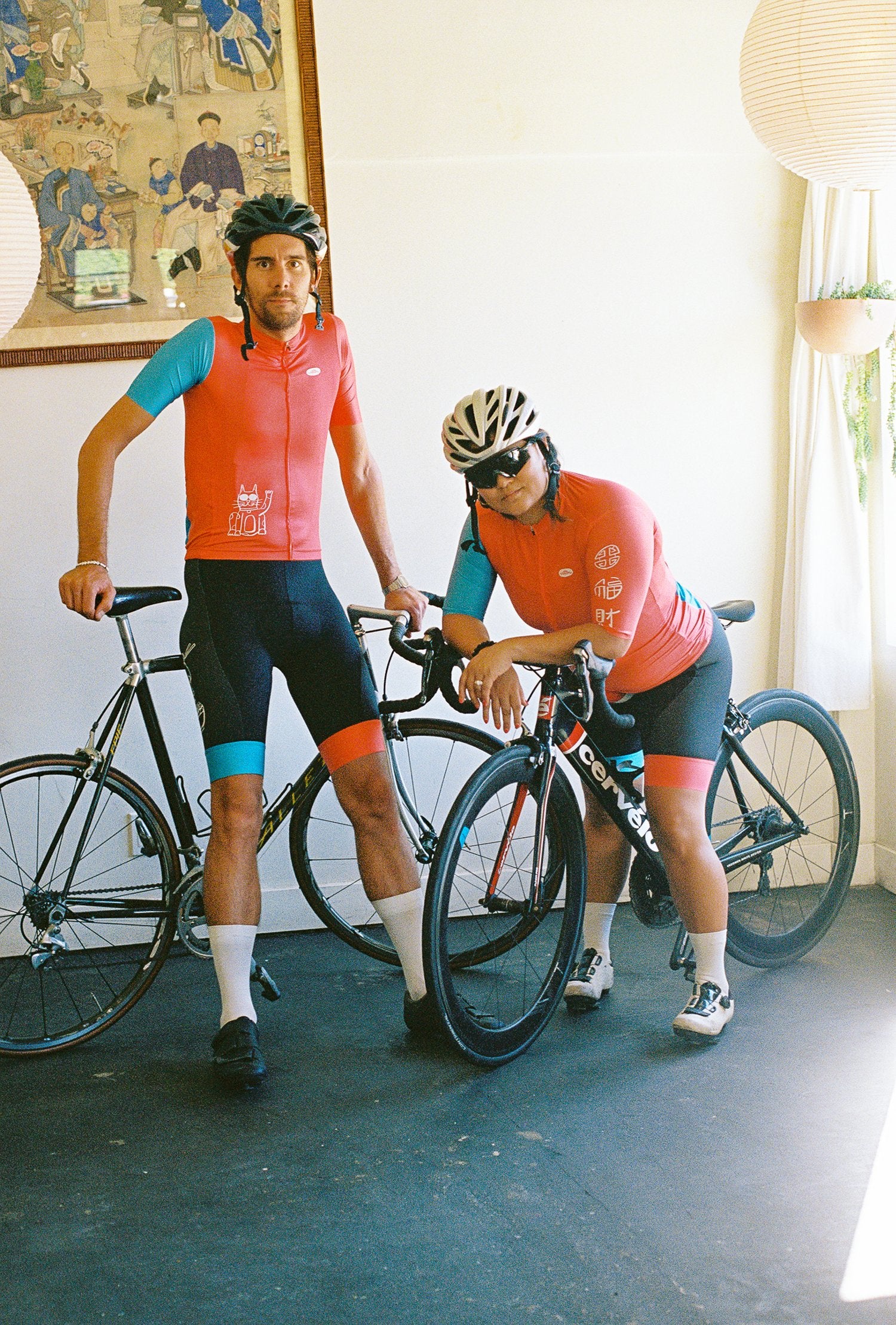 Two people wearing cycling jerseys and bibs on bikes
