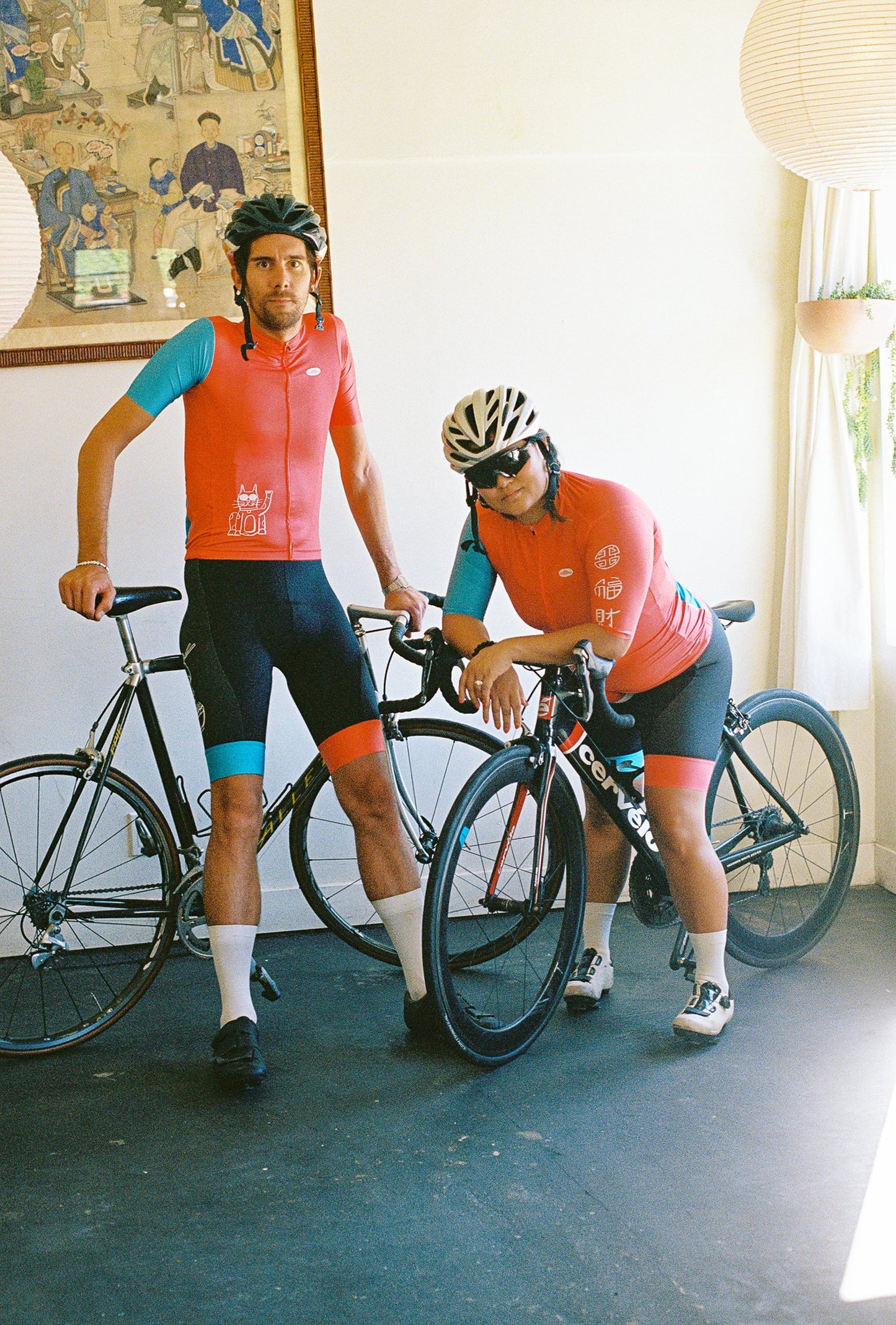 Two people wearing cycling jersey and bibs on bikes