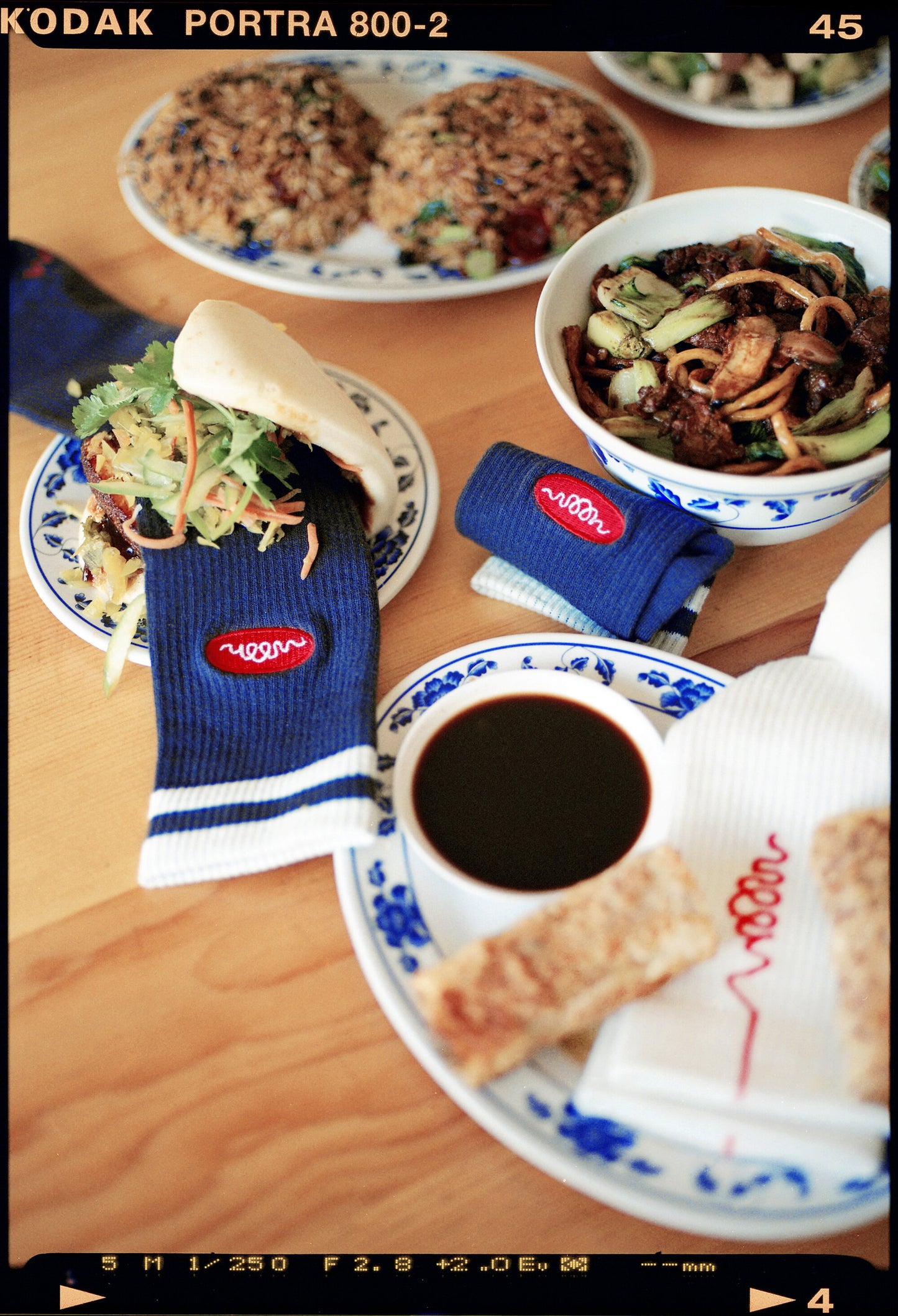 Black socks with white stripes and orange woon logo on a table with food