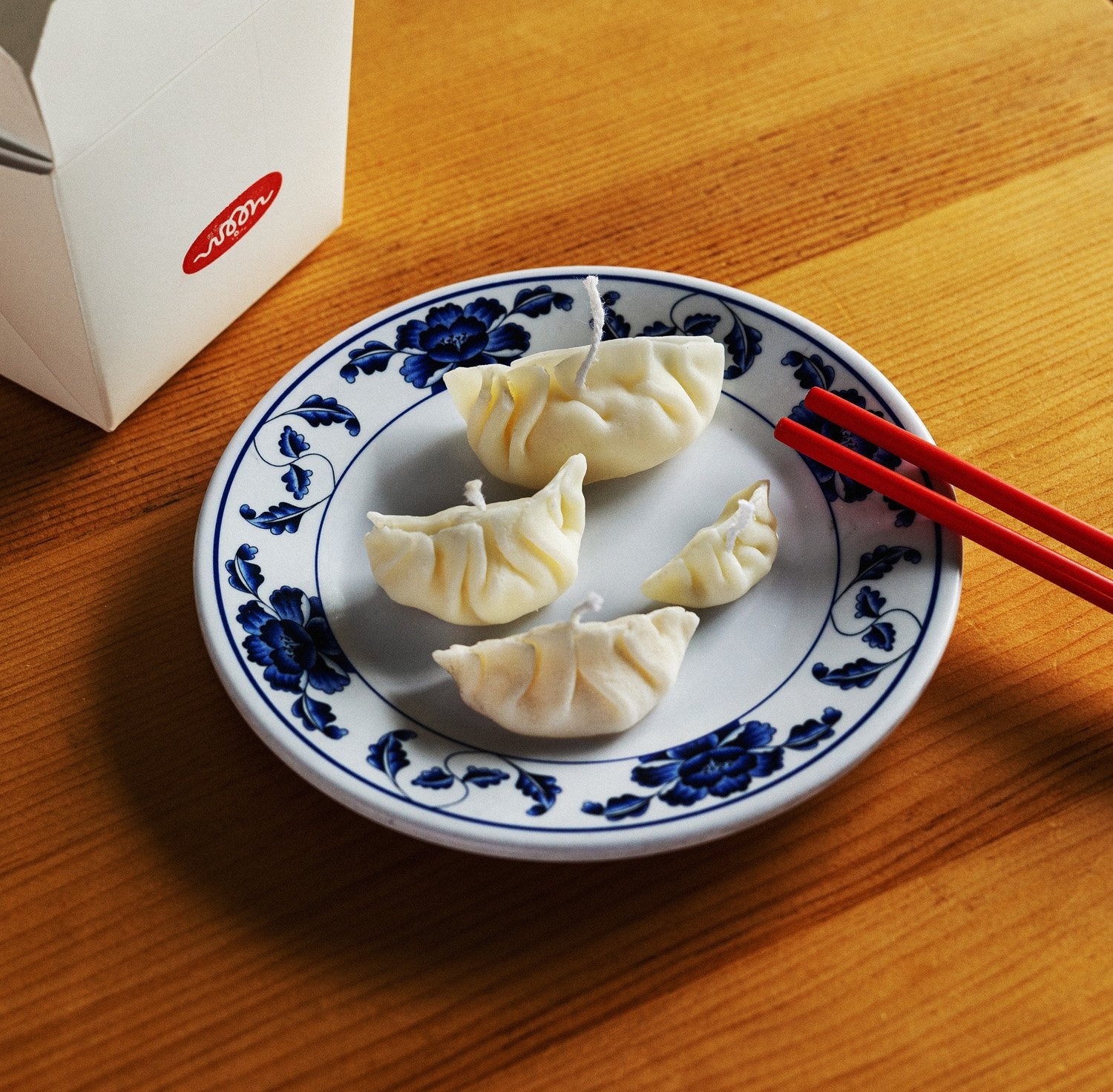Four dumpling candles on a plate