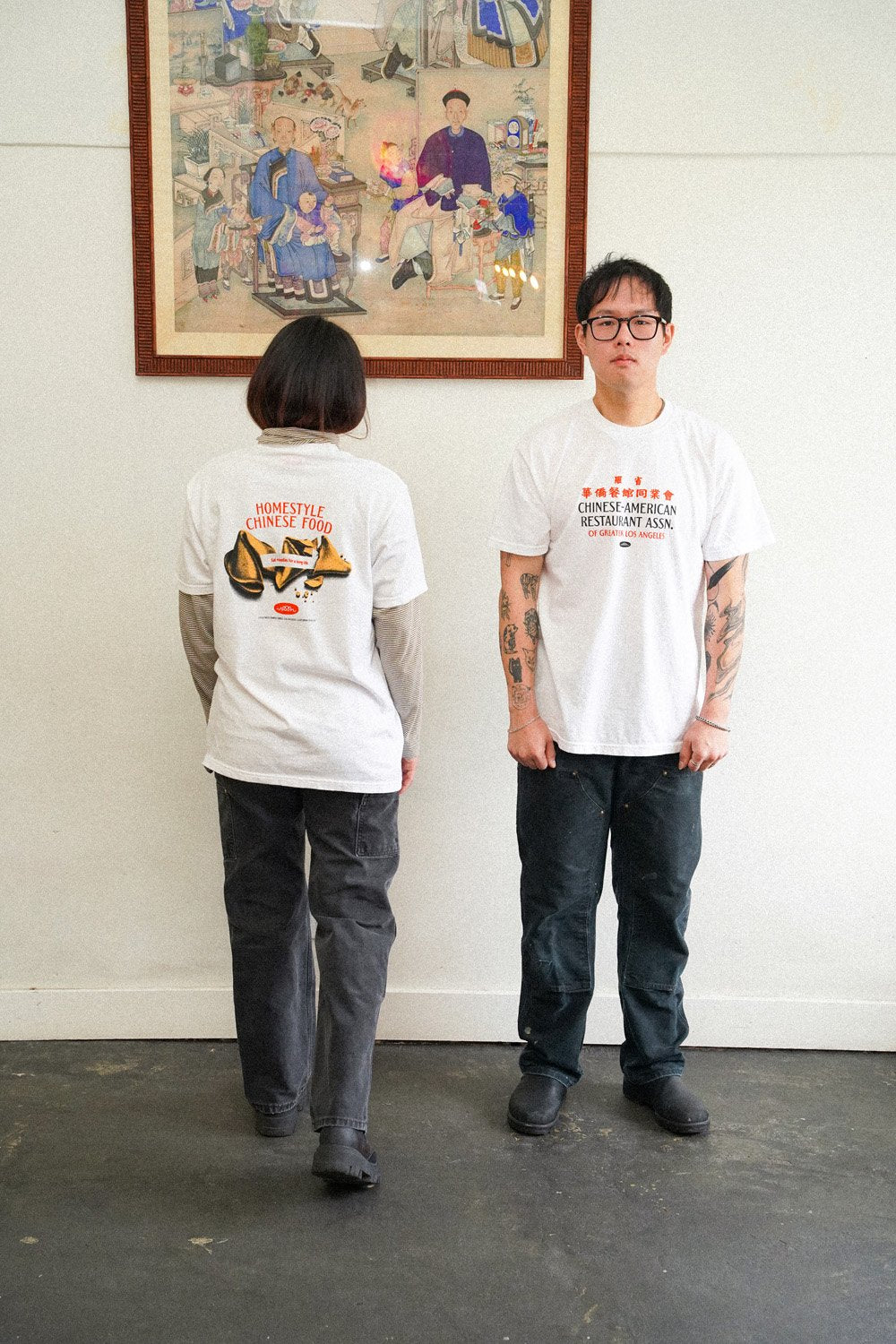 two people wearing white tshirts