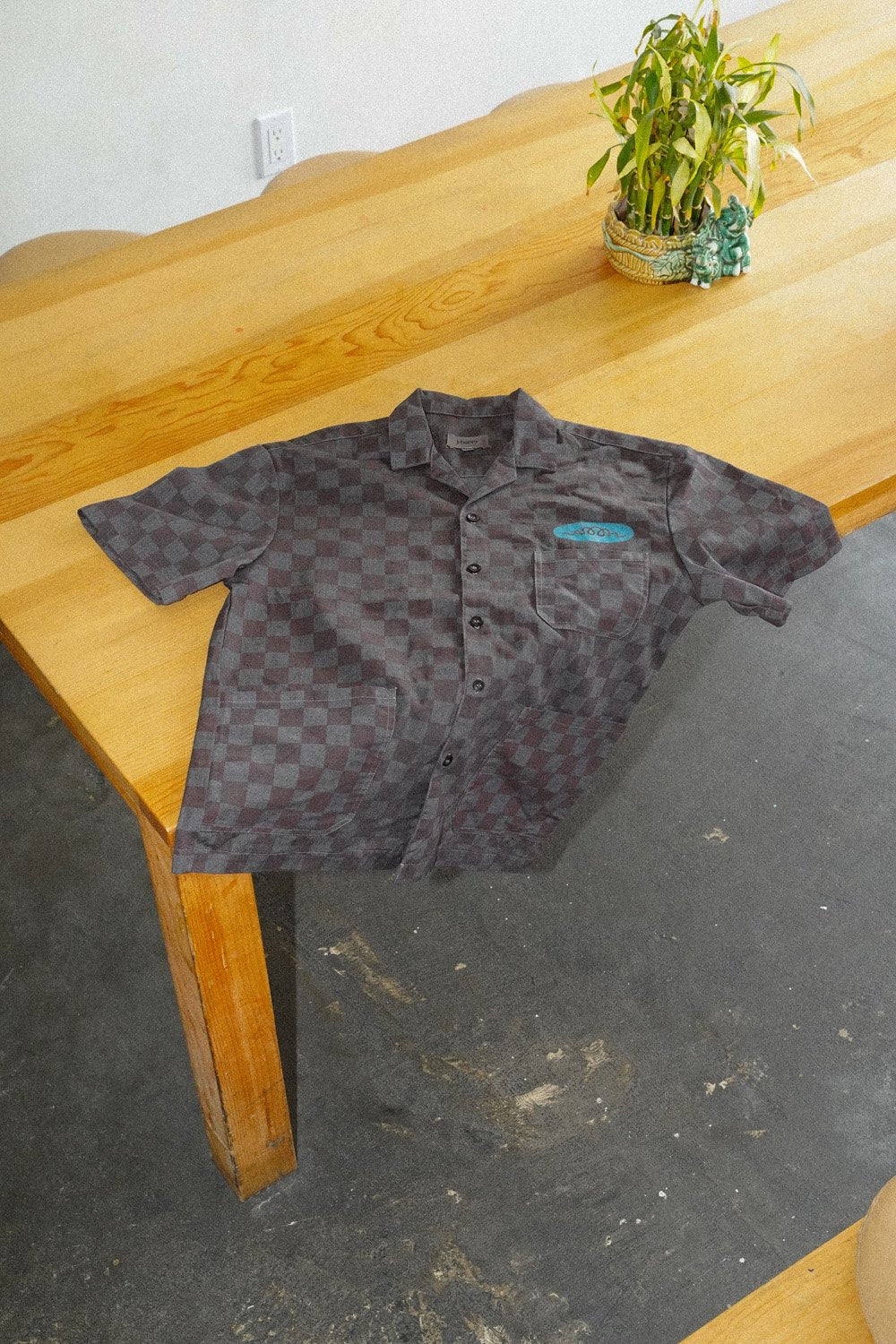 An overdyed work shirt on a wooden table