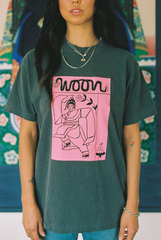 Person wearing a gray tee shirt with pink picture on it