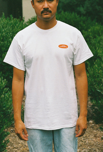 A person wearing a white tee shirt with Woon logo in orange