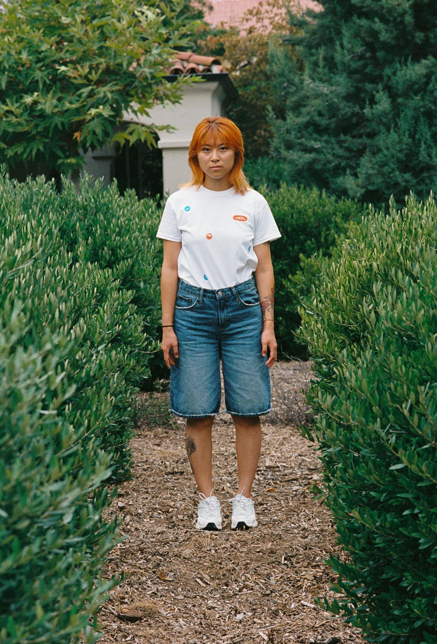 A person wearing a white tee shirt with printed take out stickers all over it