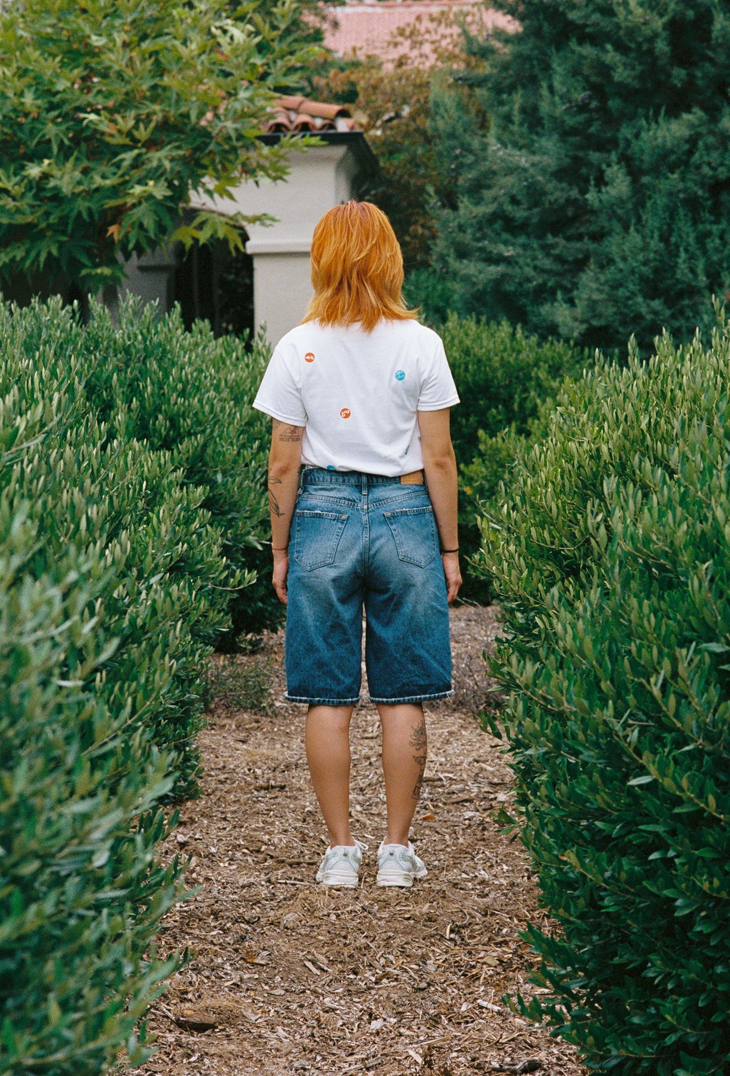 A person wearing a white tee shirt with printed take out stickers all over it