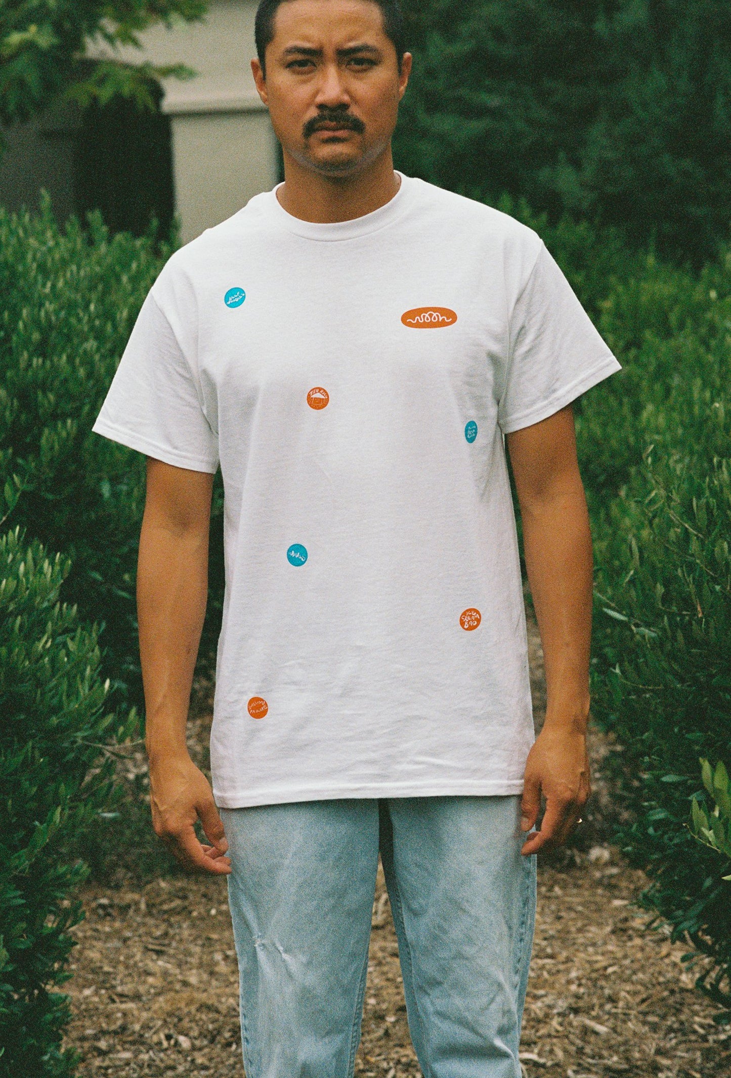 A person wearing a white tee shirt with printed take out stickers all over it