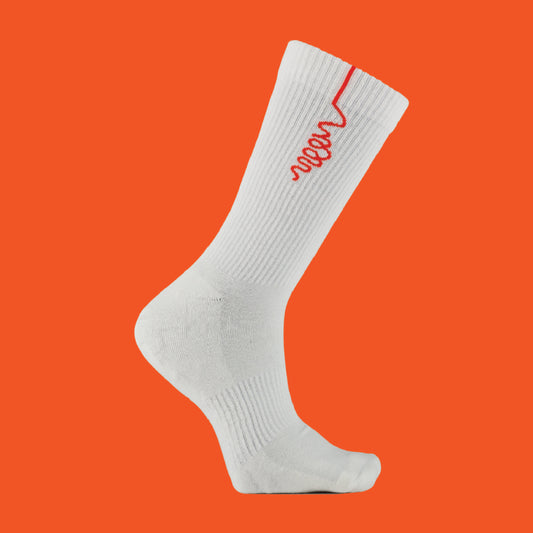 A white sock with an orange woon logo against an orange back drop