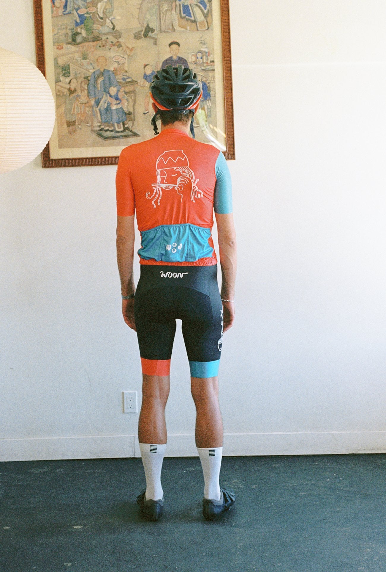 A person wearing a cycling jersey and bib