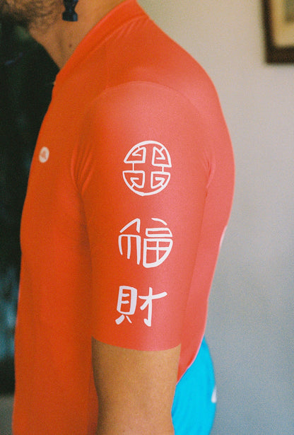 A close up of the arm of a person wearing a cycling jersey