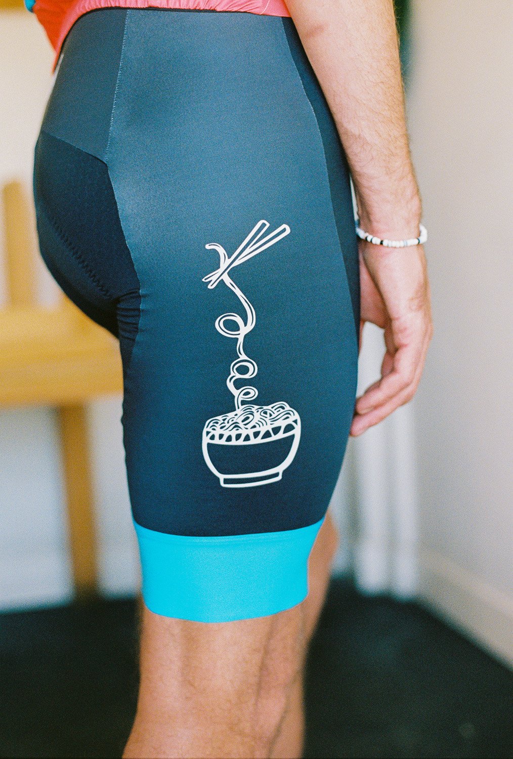 A close up of the side of cycling bib, picture of a bowl of noodles