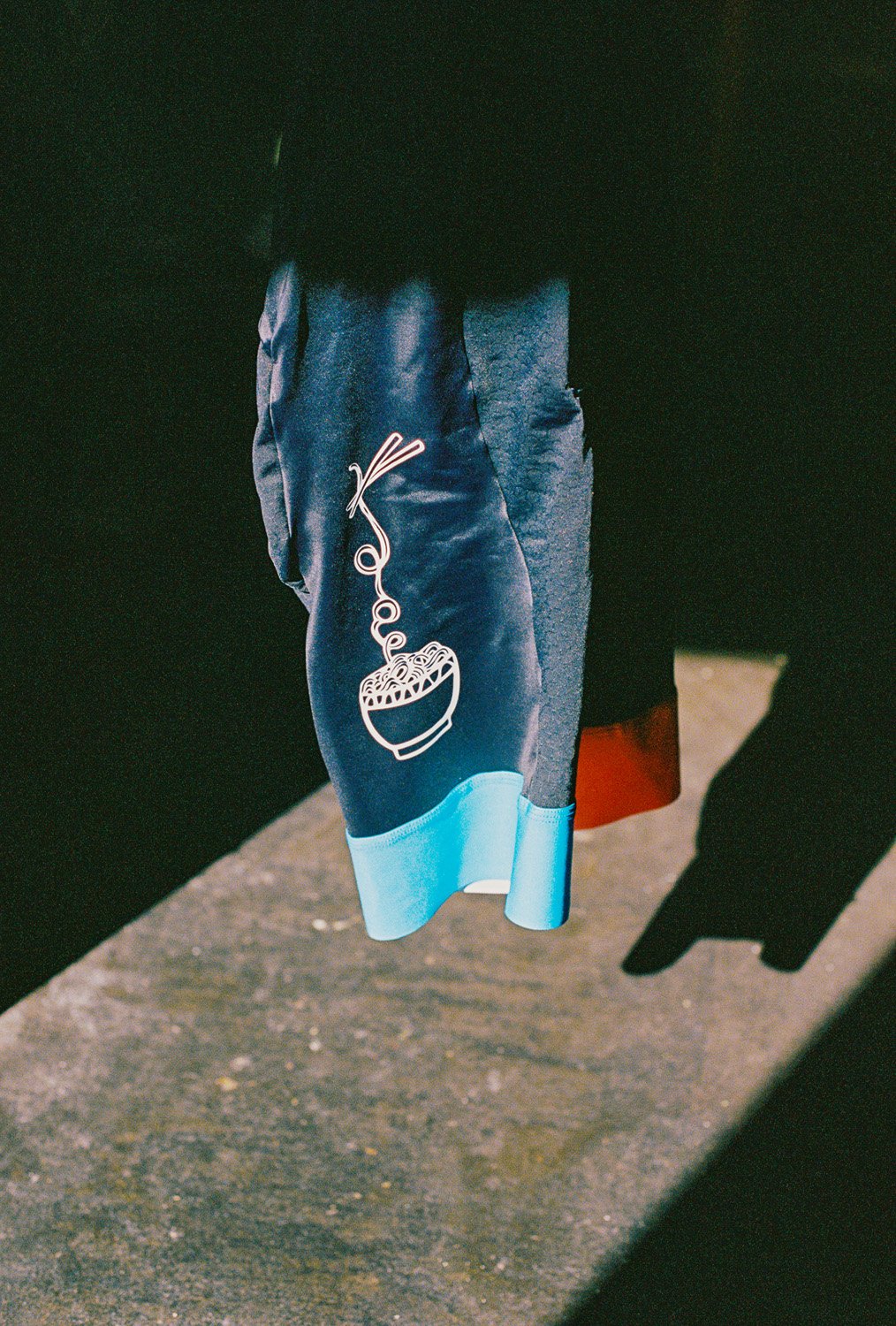 A close up of cycling bib with a bowl of noodles printed on it
