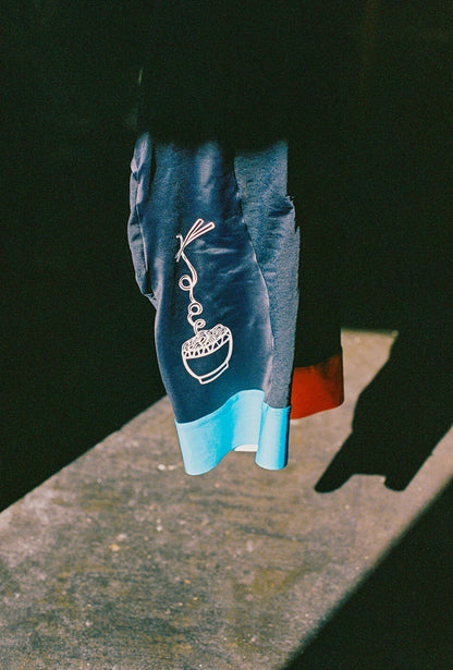 A close up of cycling bib with a bowl of noodles printed on it