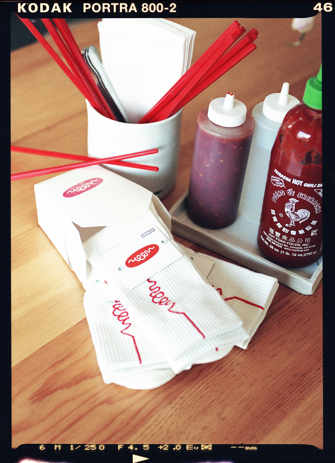 White socks with orange woon logo in a take out box